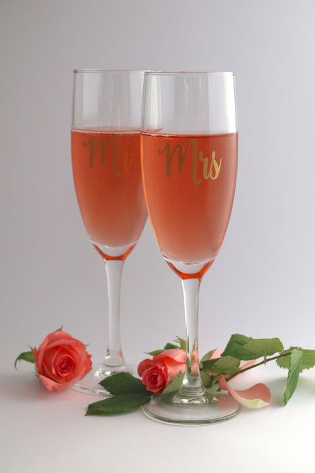 A pair of champagne flute glasses personalised with 