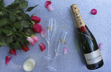 A pair of champagne flute glasses personalised with "Mr" and/or "Mrs". Perfect way to celebrate the newly married couple!