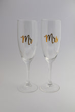 A pair of champagne flute glasses personalised with "Mr" and/or "Mrs". Perfect way to celebrate the newly married couple!